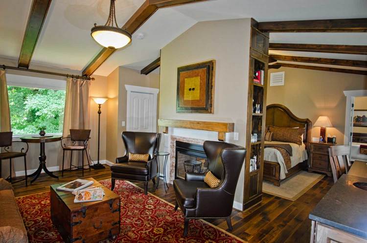 spacious seating area of king suite featuring coffee table and chairs as well as fireplace