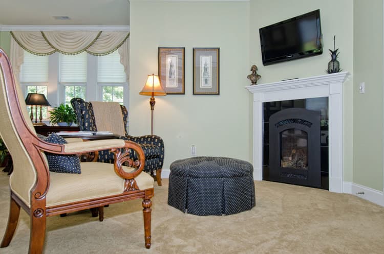 seating area in bedroom featuring fireplace and TV