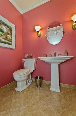 bathroom featuring pink walls and white furnishings
