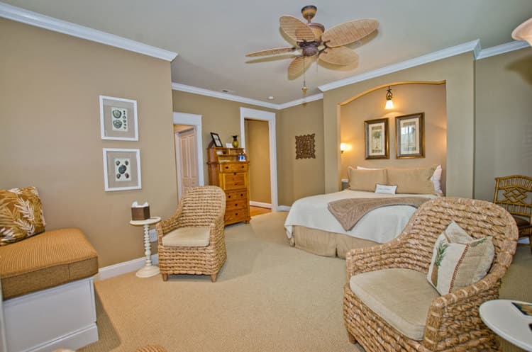 view of queen bed with seating area in the forefront