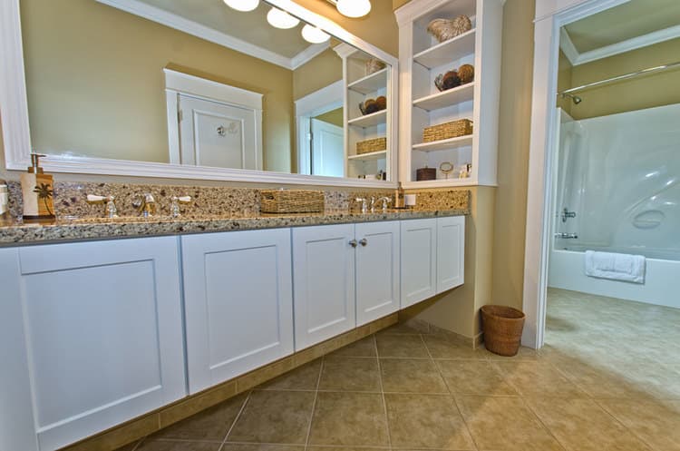spacious bathroom featuring dual sinks and bathtub