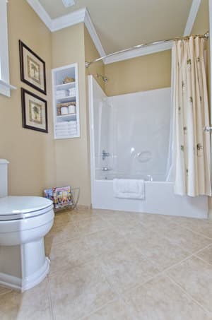 spacious bathroom - view of white bathtub with curtain