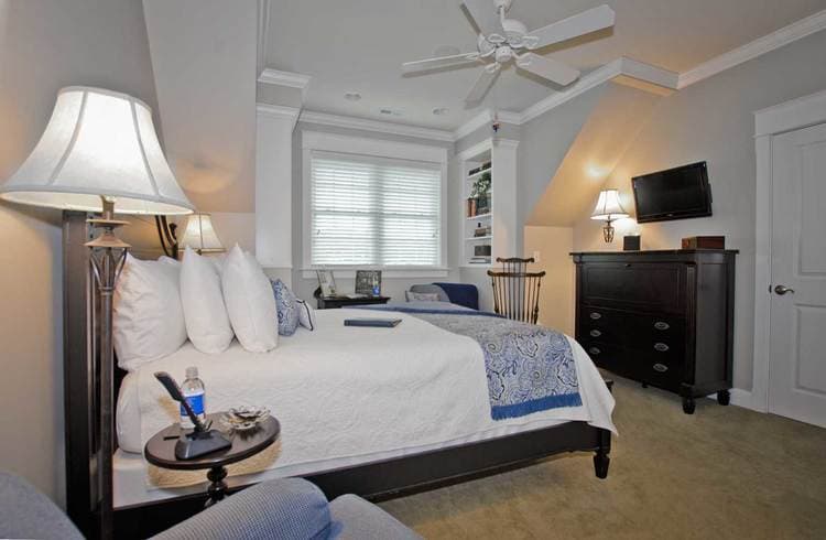 bedroom featuring queen bed and black dresser