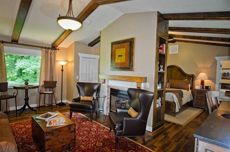 spacious seating area of king suite featuring coffee table and chairs as well as fireplace