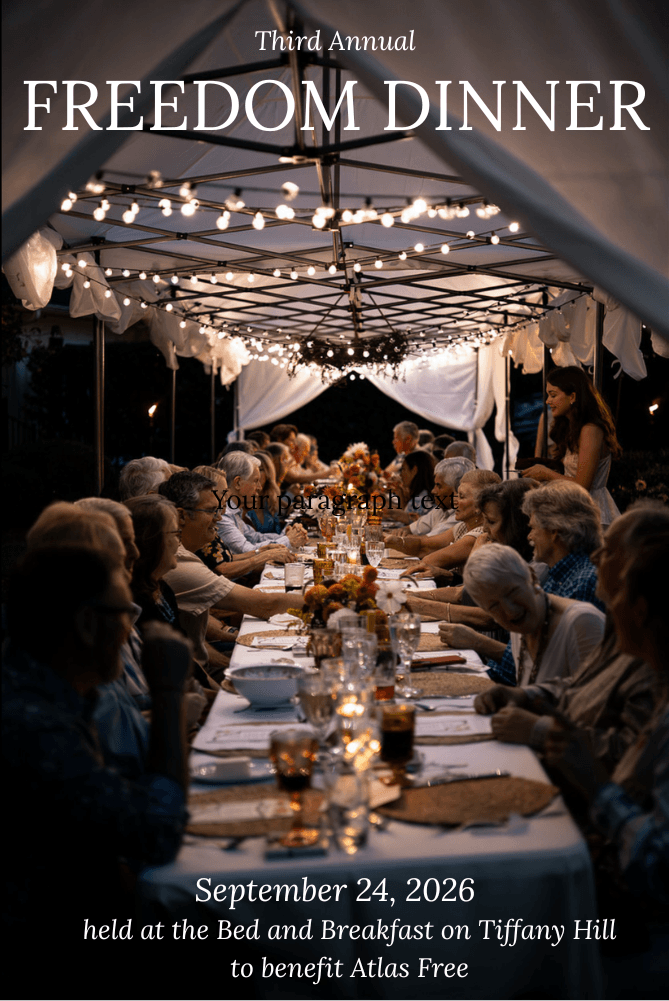 A festive outdoor dinner gathering under string lights, featuring a long table with guests enjoying a meal.